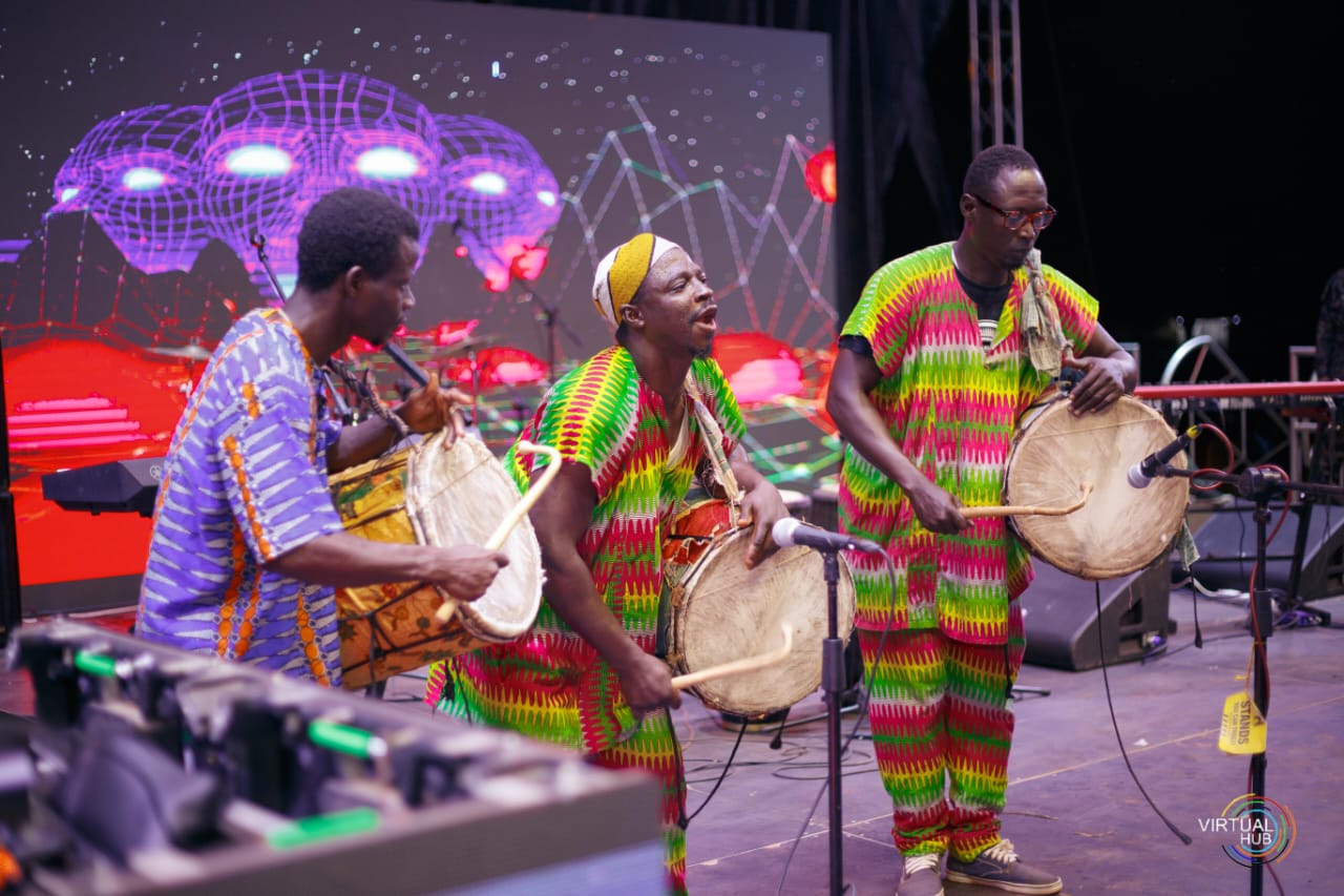 men playing drums on stage in traditional wear