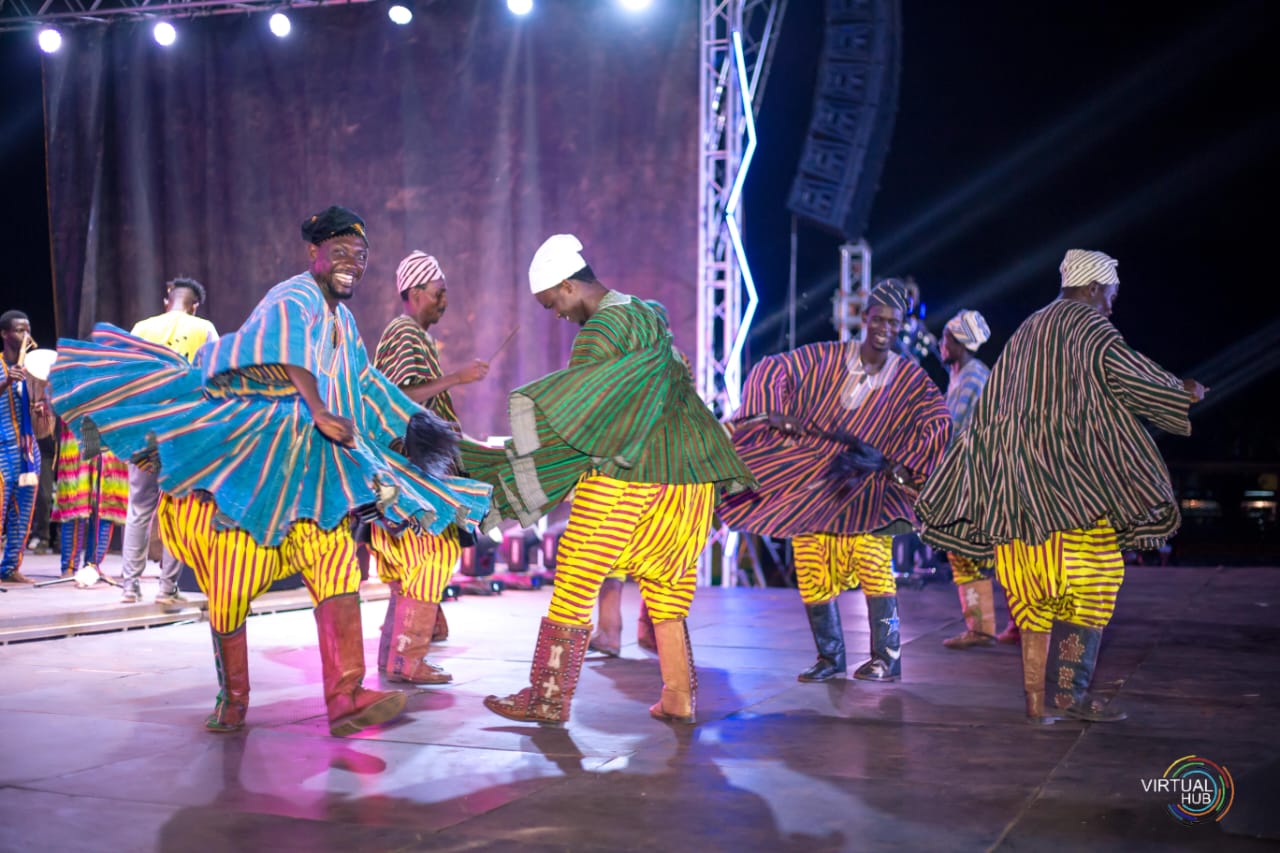 happy dancing on stage in traditional wear